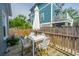Relax on the back deck with outdoor seating, a table, and an umbrella for shade at 202 Fishburne St, Charleston, SC 29403