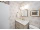 Bathroom featuring a patterned wallpaper, light wood vanity, and gold fixtures at 202 Fishburne St, Charleston, SC 29403