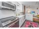 Well-lit kitchen featuring stainless steel appliances, white cabinets, and subway tile backsplash at 202 Fishburne St, Charleston, SC 29403