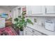 Bright kitchen with white cabinetry, white countertops and decorative details at 202 Fishburne St, Charleston, SC 29403