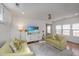 Cozy living room featuring two green sofas, a ceiling fan, and a flat-screen TV at 202 Fishburne St, Charleston, SC 29403