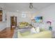 Bright living room with hardwood floors, two green sofas, and built-in cabinets at 202 Fishburne St, Charleston, SC 29403