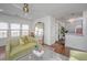 Inviting living room with hardwood floors and a large mirror reflecting ample sunlight at 202 Fishburne St, Charleston, SC 29403