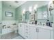 Well-lit bathroom showcasing a double vanity with marble countertop and framed mirrors at 21 George St # 203, Charleston, SC 29401