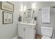 Charming powder room with stylish vanity, and framed wall art at 21 George St # 203, Charleston, SC 29401
