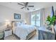 Comfortable bedroom featuring a ceiling fan, ample natural light, and stylish décor creating a cozy atmosphere at 21 George St # 203, Charleston, SC 29401