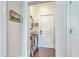 View of the front door from an entryway with a small table, mirror, and painting on the wall at 21 George St # 203, Charleston, SC 29401
