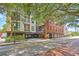 Brick building with a mix of residential and commercial spaces nestled in a charming neighborhood with mature trees at 21 George St # 203, Charleston, SC 29401