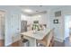 Bright kitchen features white cabinets, stainless steel appliances, and an island with marble countertop and wicker barstools at 21 George St # 203, Charleston, SC 29401