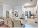 Bright kitchen features white cabinets, stainless steel appliances, and an island with marble countertop and wicker barstools at 21 George St # 203, Charleston, SC 29401