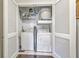Functional laundry room featuring a washer and dryer setup, open shelving, and convenient storage at 21 George St # 203, Charleston, SC 29401