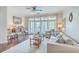 Cozy living room features a neutral color scheme, comfortable seating, and large windows that provide natural light at 21 George St # 203, Charleston, SC 29401
