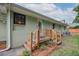 Backyard featuring a wooden staircase leading up to the back entrance of the home at 22 Charlestowne Rd, Charleston, SC 29407