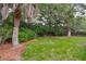 Spacious backyard with mature trees and lush greenery, offering privacy and a serene outdoor space at 22 Charlestowne Rd, Charleston, SC 29407