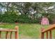 Wooden stairs leading to backyard, featuring mature trees, green grass, and a storage shed at 22 Charlestowne Rd, Charleston, SC 29407