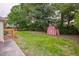 Backyard featuring a well maintained lawn with a utility shed offering additional storage space at 22 Charlestowne Rd, Charleston, SC 29407