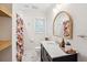 Charming bathroom with a floral shower curtain, marble countertop vanity, and modern fixtures, offering a fresh aesthetic at 22 Charlestowne Rd, Charleston, SC 29407