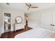 Bright bedroom with hardwood floors, a ceiling fan, and an ensuite bathroom with modern fixtures at 22 Charlestowne Rd, Charleston, SC 29407