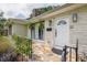 Charming front exterior of home with stone facade, manicured landscaping, and updated lighting fixtures at 22 Charlestowne Rd, Charleston, SC 29407