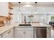 Open concept kitchen featuring stainless steel appliances, a stone countertop, and modern pendant lighting at 22 Charlestowne Rd, Charleston, SC 29407