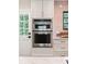 Kitchen appliances and hardware are stainless steel in this bright kitchen with white cabinets and countertops at 22 Charlestowne Rd, Charleston, SC 29407