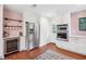 Kitchen boasts stainless steel refrigerator, wine cooler, and oven, complemented by white cabinetry and sleek countertops at 22 Charlestowne Rd, Charleston, SC 29407
