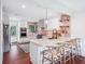 Modern kitchen featuring white cabinets, marble countertops, stylish backsplash, and an island with seating at 22 Charlestowne Rd, Charleston, SC 29407