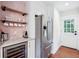 Modern kitchen featuring stainless steel refrigerator, wine cooler, and a stylish coffee bar area at 22 Charlestowne Rd, Charleston, SC 29407