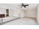 An open living room with neutral carpet and walls, ceiling fan, and closet space at 22 Charlestowne Rd, Charleston, SC 29407