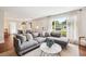 Open-concept living room with large sectional sofa and views of the dining area and front yard at 22 Charlestowne Rd, Charleston, SC 29407