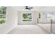 Bright living room with large windows showcasing the front yard at 22 Charlestowne Rd, Charleston, SC 29407