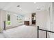 This living room has carpeted floors, a front door and window, and an additional room adjacent at 22 Charlestowne Rd, Charleston, SC 29407