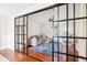 Living room area with sliding black-framed glass doors, hardwood floors, and a comfortable seating area at 22 Charlestowne Rd, Charleston, SC 29407