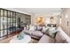 Open concept living room with hardwood floors, comfortable seating, and an open view to the kitchen at 22 Charlestowne Rd, Charleston, SC 29407