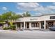 Commercial building with shops Wild Craft, Bashful, and Well Furnished under a cloudy sky at 22 Charlestowne Rd, Charleston, SC 29407