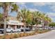 Shops including Antiques under palm trees with parked cars on the street in the daytime at 22 Charlestowne Rd, Charleston, SC 29407