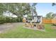 Spacious backyard featuring a seating area with a fire pit, surrounded by grass and a wooden fence at 2317 Kent Ave, North Charleston, SC 29405