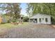 Large backyard featuring a guest house, gravel area, and a seating area with a fire pit at 2317 Kent Ave, North Charleston, SC 29405
