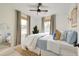 This bedroom features natural light from two windows, a ceiling fan, and a neutral rug at 2317 Kent Ave, North Charleston, SC 29405