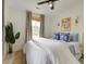 Bright bedroom featuring a white comforter, neutral rug, ceiling fan, and natural light through the window at 2317 Kent Ave, North Charleston, SC 29405