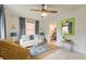 Bright living room features a modern ceiling fan, white couch, stylish rug, and a lime green mirror at 2317 Kent Ave, North Charleston, SC 29405