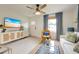 Stylish living room with light wood floors, a white couch, and a television with ocean scenery at 2317 Kent Ave, North Charleston, SC 29405