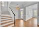 Welcoming entryway with hardwood floors, staircase, and stylish light fixture at 2516 Willbrook Ln, Mount Pleasant, SC 29466