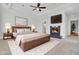 Well-appointed main bedroom featuring a fireplace, ceiling fan, and a luxurious king-size bed at 2516 Willbrook Ln, Mount Pleasant, SC 29466