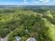 Stunning aerial view of lush green landscape with scattered homes and a golf course under a bright blue sky with fluffy clouds at 2653 Seabrook Island Rd, Seabrook Island, SC 29455