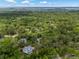Scenic aerial view of a home nestled within a lush green landscape, showcasing a tranquil and private setting at 2653 Seabrook Island Rd, Seabrook Island, SC 29455