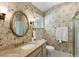 Elegant bathroom featuring floral wallpaper, an oval mirror, and a marble countertop at 2653 Seabrook Island Rd, Seabrook Island, SC 29455