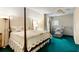 Charming bedroom with a four-poster bed, cozy chair, and ample natural light at 2653 Seabrook Island Rd, Seabrook Island, SC 29455