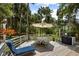 Outdoor deck with lounge chair and dining table, surrounded by lush trees at 2653 Seabrook Island Rd, Seabrook Island, SC 29455