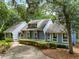 Charming home exterior with blue siding, neat landscaping, and an American flag waving by the cozy entrance at 2653 Seabrook Island Rd, Seabrook Island, SC 29455